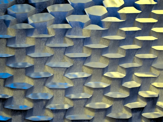 A close up of a metal surface with blue and yellow colors